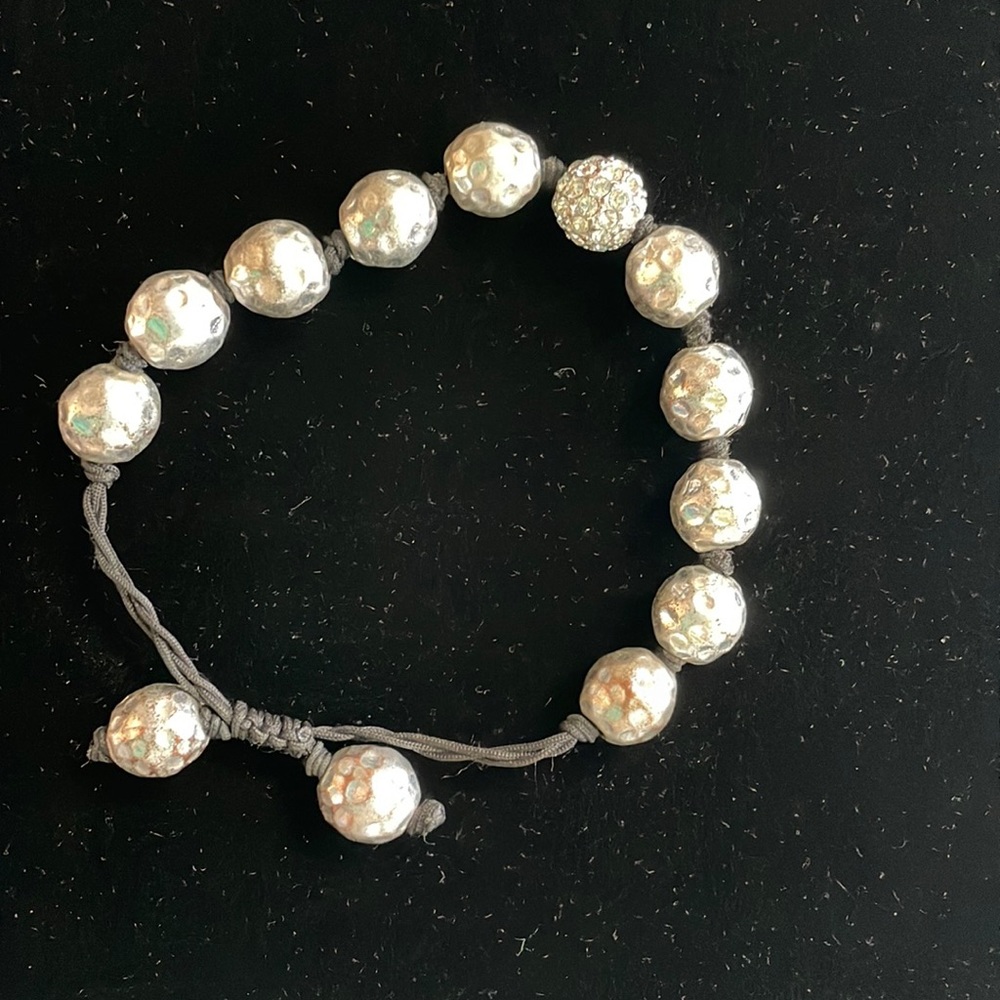 Sliver beaded bracket. hammered beads with crystal stone bead.